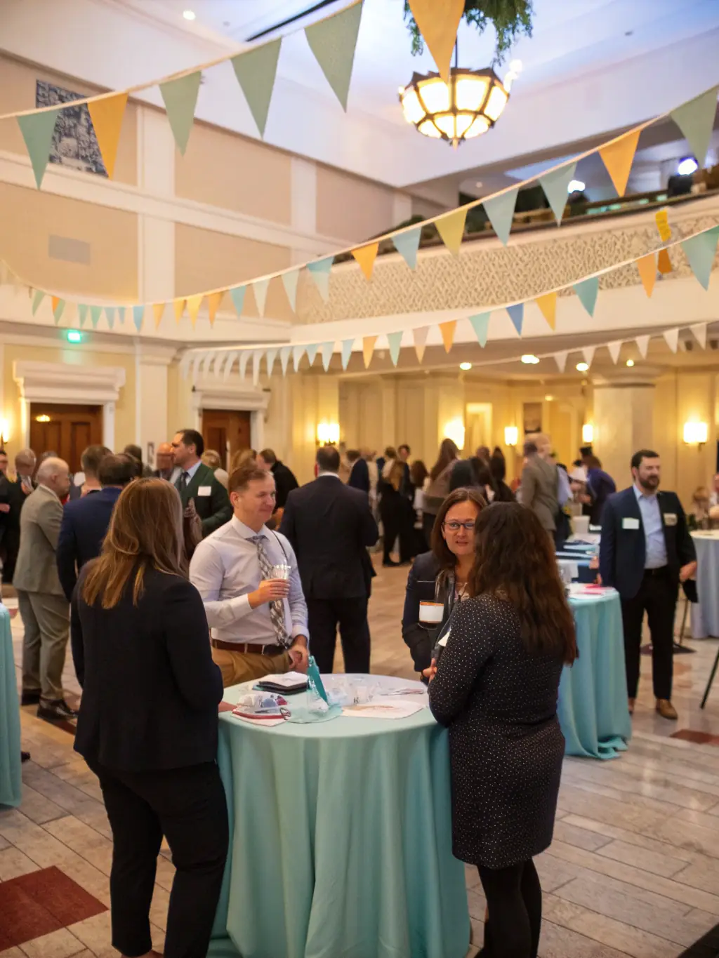 A high-quality image of a networking event at a FocusPro leadership conference in Montreal, Canada, with attendees engaging in lively conversations over refreshments.