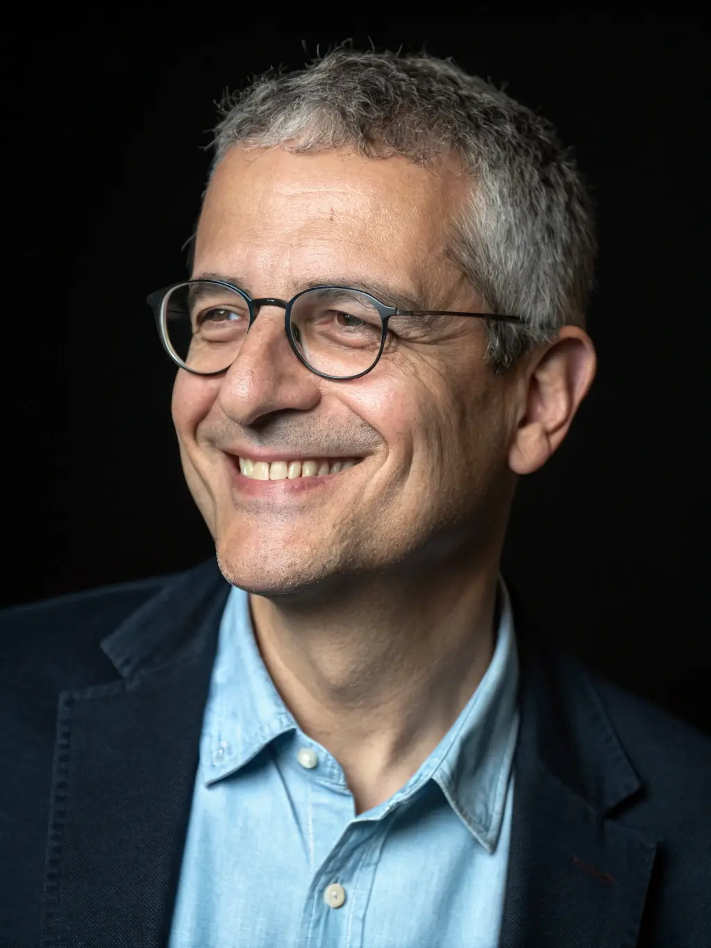 A professional headshot of Mr. David Lee, a leadership coach and author, looking thoughtful and engaged. He is a speaker at the FocusPro Leadership Conference.