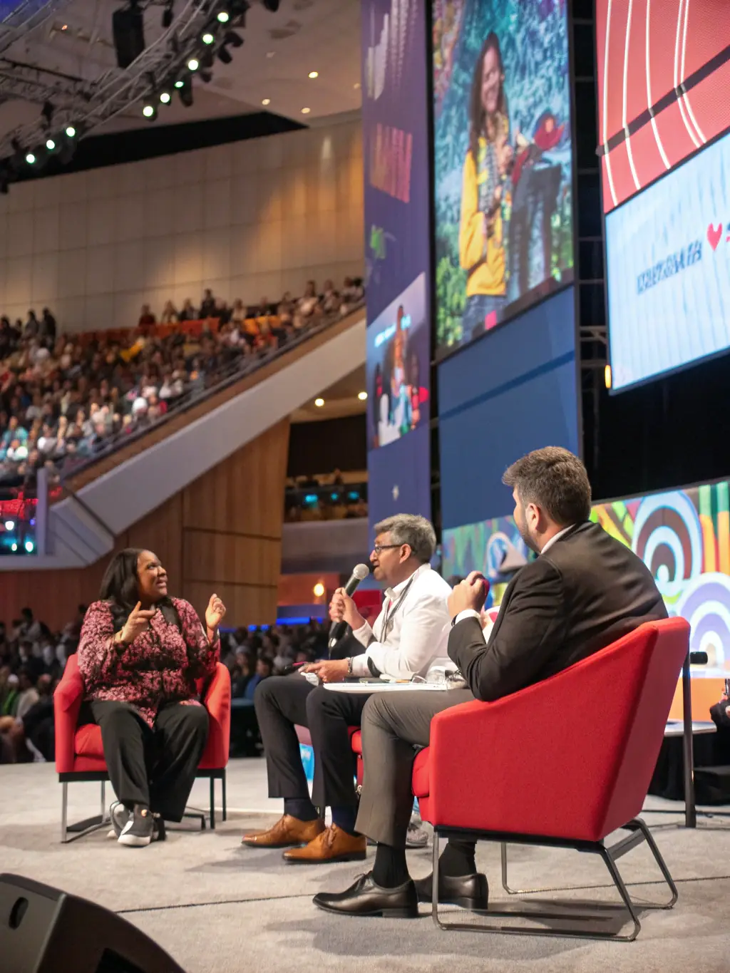 A photograph of a panel discussion featuring industry leaders at a leadership conference in Montreal, Canada. The panelists are engaged in a lively debate.